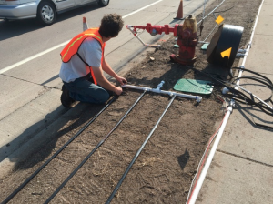 Researcher installing turf irrigation.