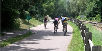 Three riders on a bike trail.