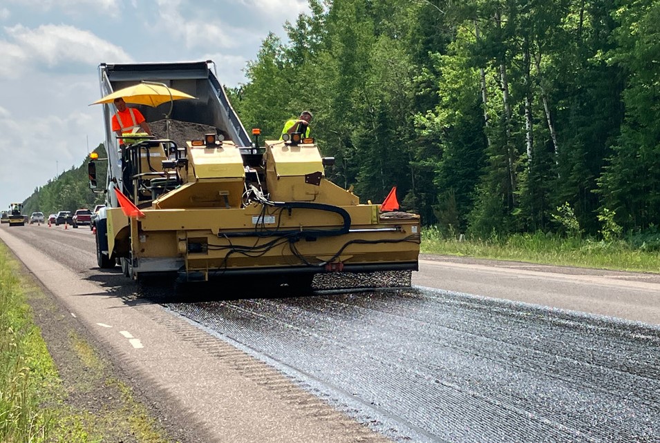 Maintenance crew seal coats Minnesota road