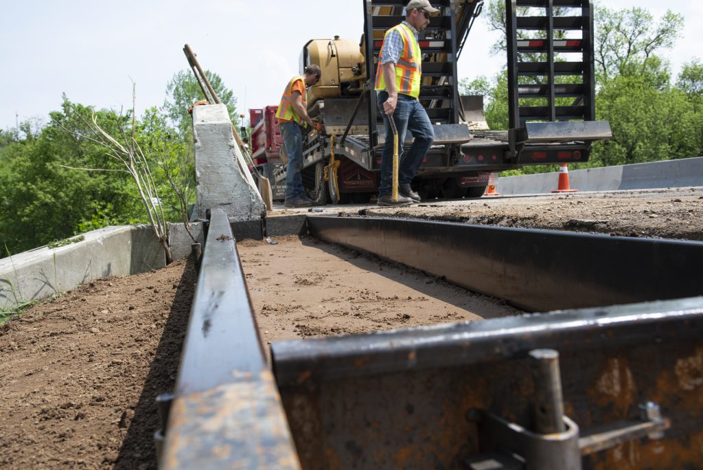 Maintenance activity on a bridge curb